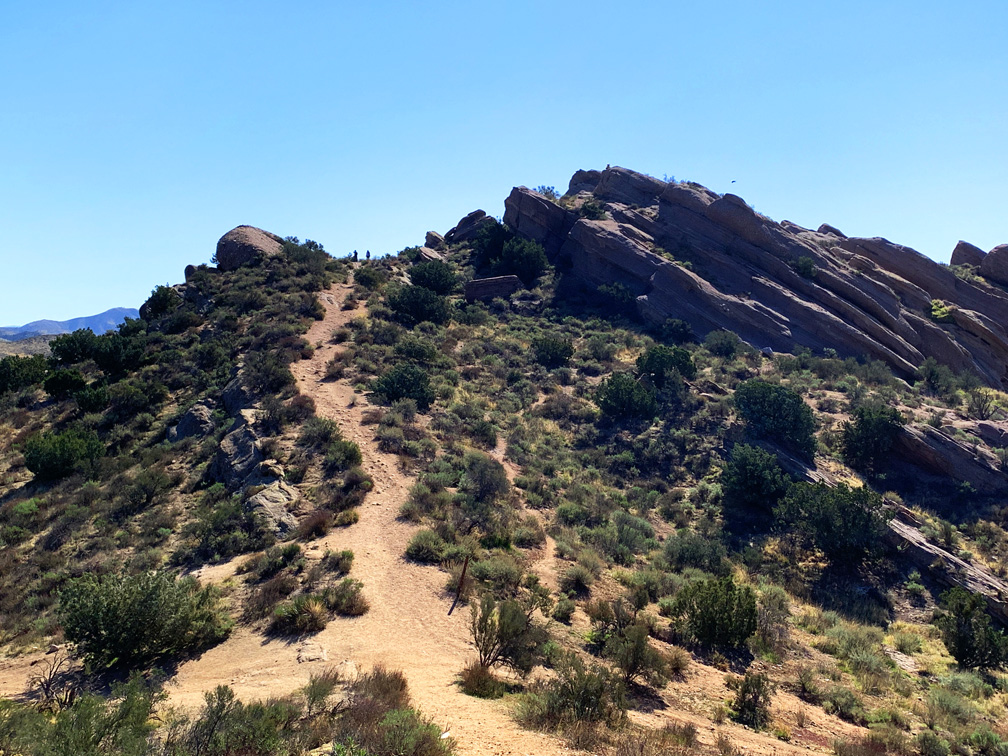 There are main trails and smaller foot trails run through the Vasquez Rocks Natural Park Area that offer views of rock formations slanting out of the ground.