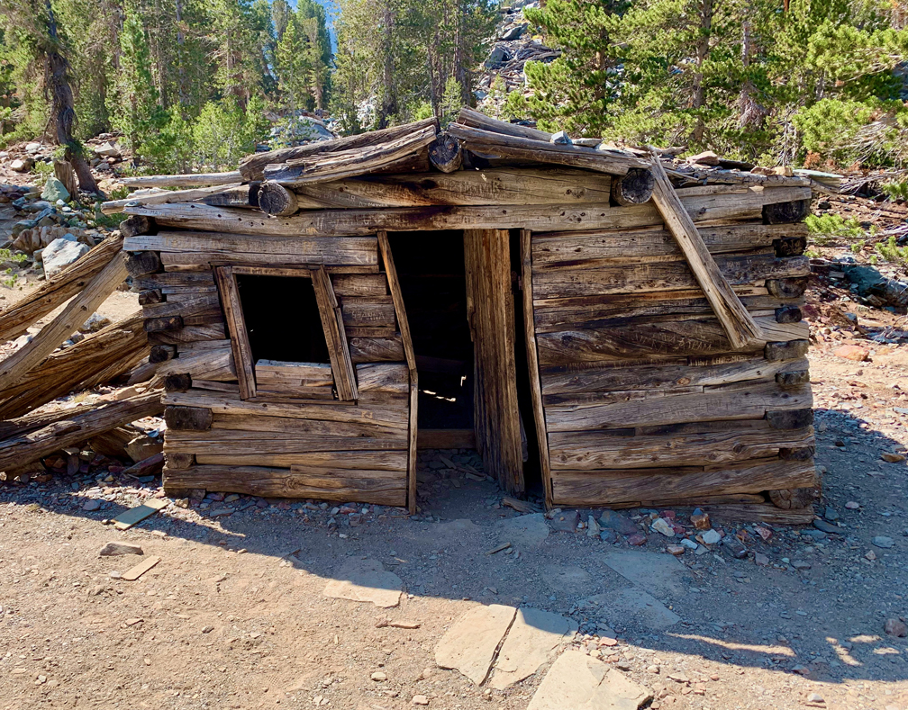 An old miner's cabin in a state of decay stands near the Virginal Lakes Trail.