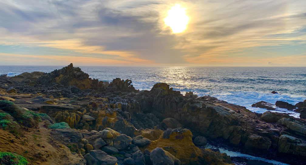 The sun sets over the Pacific Ocean.