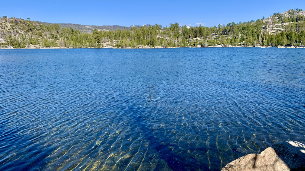 Buck Island Lake with forest and mountain ridges in the background.