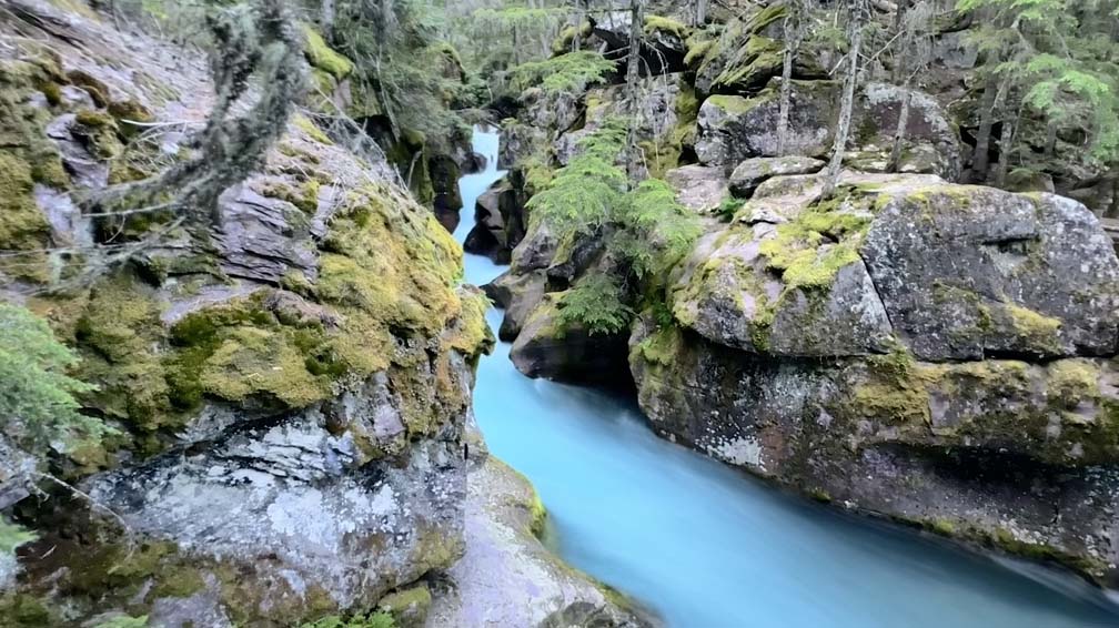 The water of Avalanche Creek runs through a granite rock chasm.