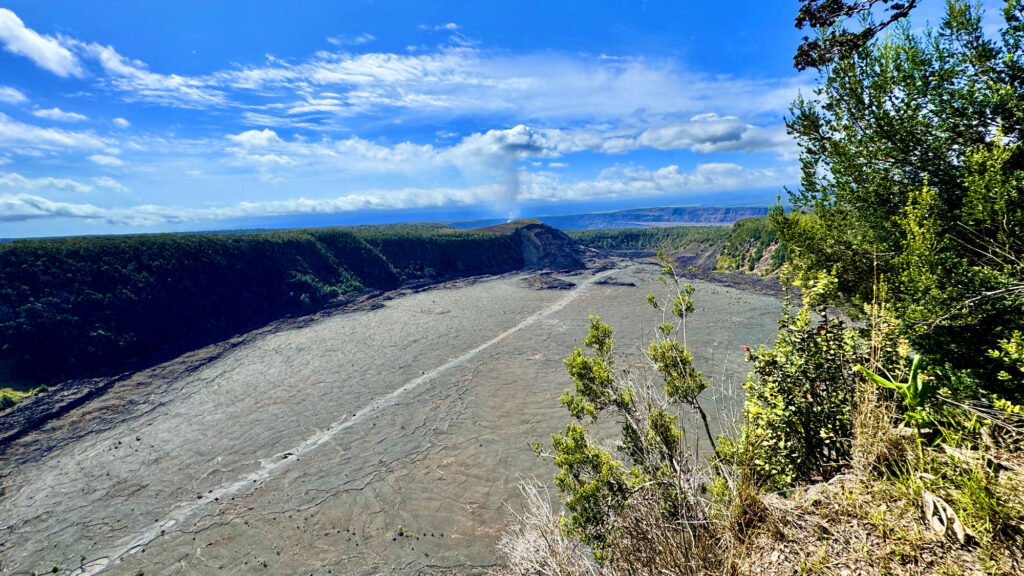 A trail crosses a volcanic crater at Hawai‘i Volcanoes National Park.